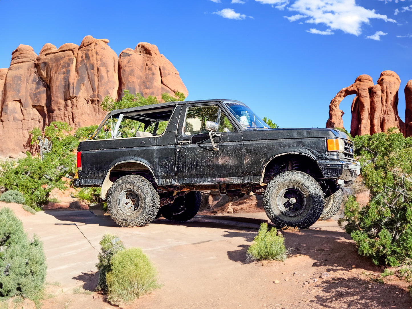 Ford Bronco with Bikini Top off roading in Arches National Park Utah. 